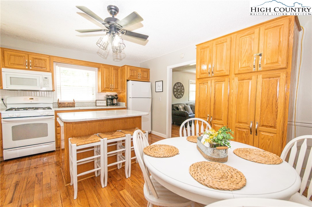 1268 Pine Run Road Boone, NC 28607 - Photo 15 of 48 a kitchen with a table chairs stove and kitchen view