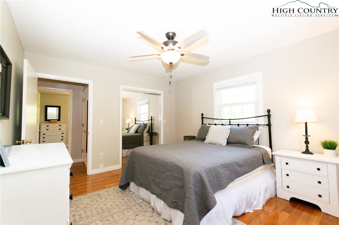 1268 Pine Run Road Boone, NC 28607 - Photo 17 of 48 a bedroom with a bed and a chandelier