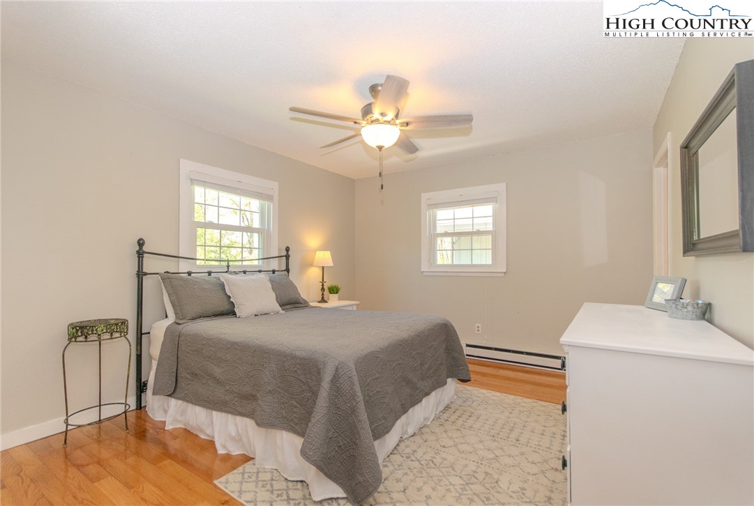 1268 Pine Run Road Boone, NC 28607 - Photo 18 of 48 a bedroom with a bed and a chandelier