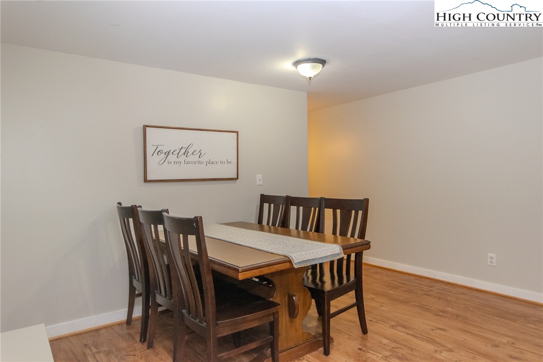 1268 Pine Run Road Boone, NC 28607 - Photo 34 of 48 a view of a dining room with furniture and wooden floor