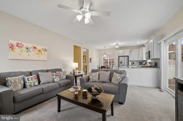 a living room with furniture and kitchen view