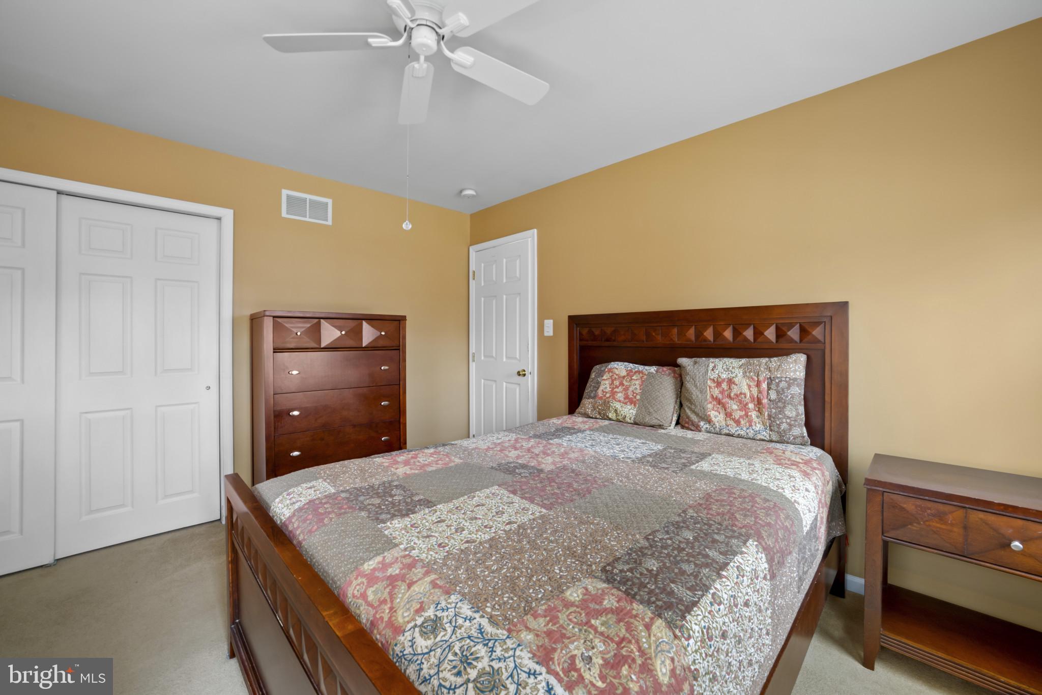 211 South Norwinden Drive Springfield, PA 19064 - Photo 24 of 38 a bedroom with a large bed and a chandelier