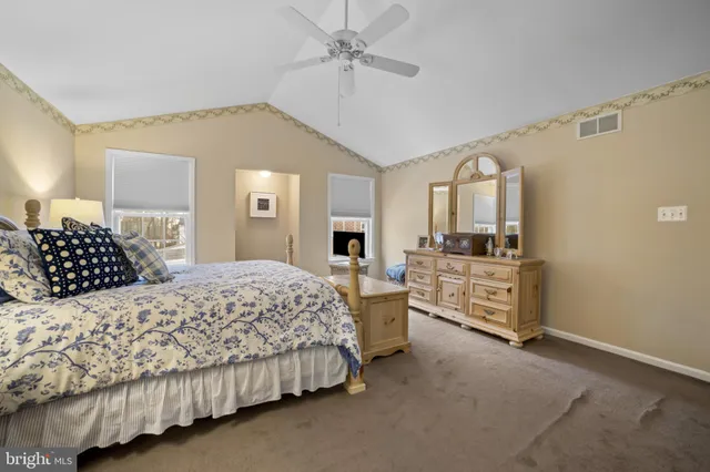 a bedroom with a bed and ceiling fan