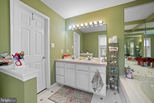 a bathroom with a sink mirror and vanity