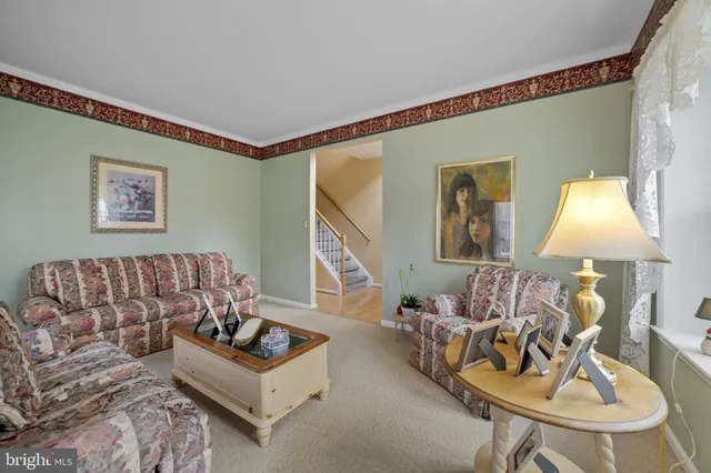 a living room with furniture and a lamp