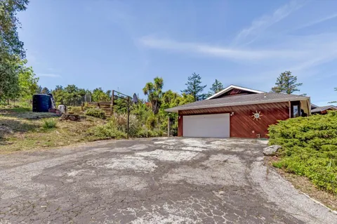 a view of a house with a yard and a garage