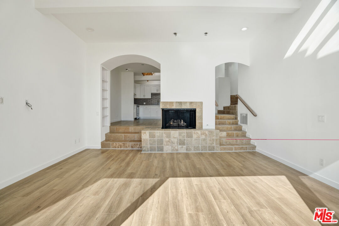 31246 Bailard Road Malibu, CA 90265 - Photo 11 of 31 a view of empty room with a fireplace and wooden floor