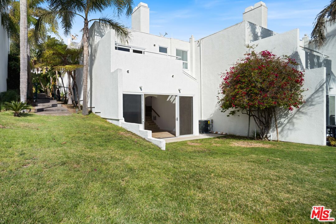 31246 Bailard Road Malibu, CA 90265 - Photo 15 of 31 a view of a white house with a yard and palm trees