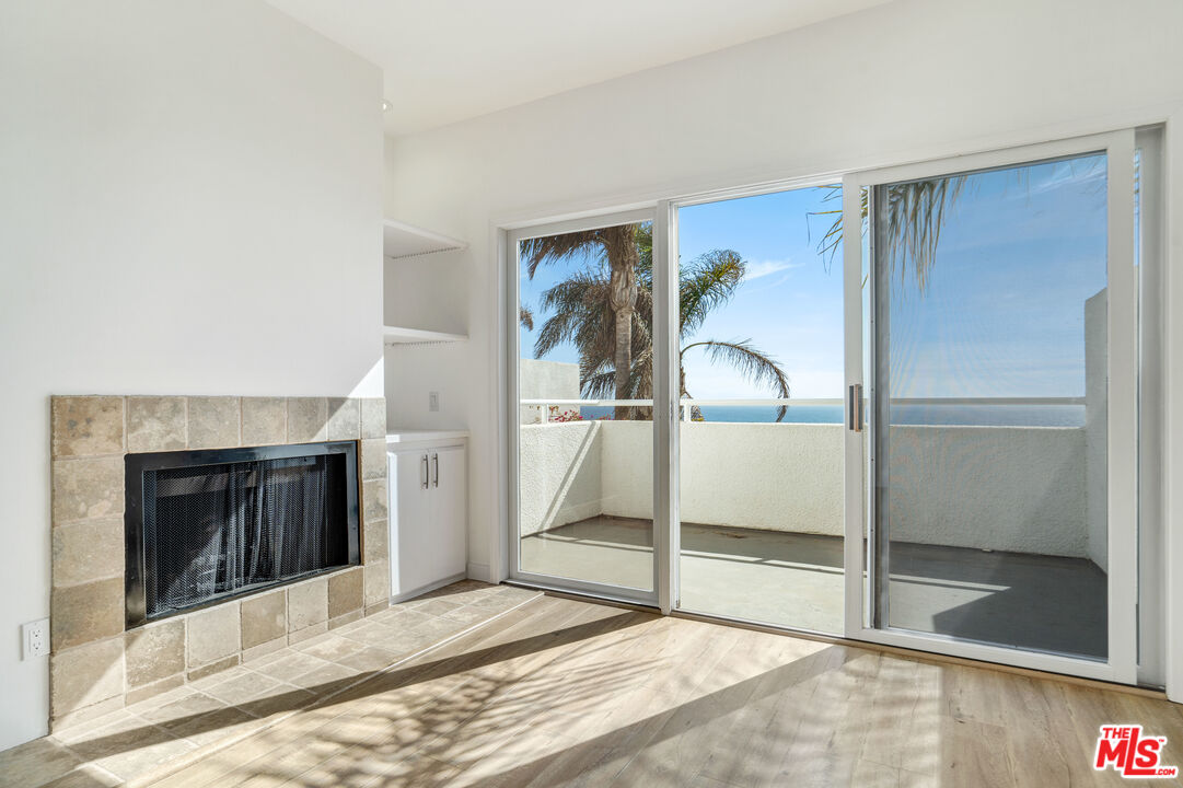 31246 Bailard Road Malibu, CA 90265 - Photo 19 of 31 a bedroom with a bed and a fireplace