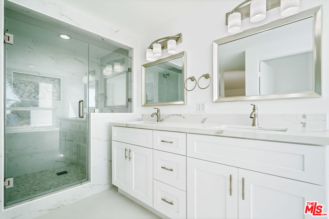 31246 Bailard Road Malibu, CA 90265 - Photo 24 of 31 a bathroom with double sink and a mirror