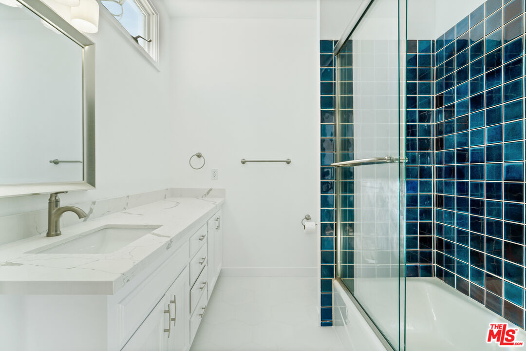 31246 Bailard Road Malibu, CA 90265 - Photo 26 of 31 a bathroom with a granite countertop sink a shower and a mirror