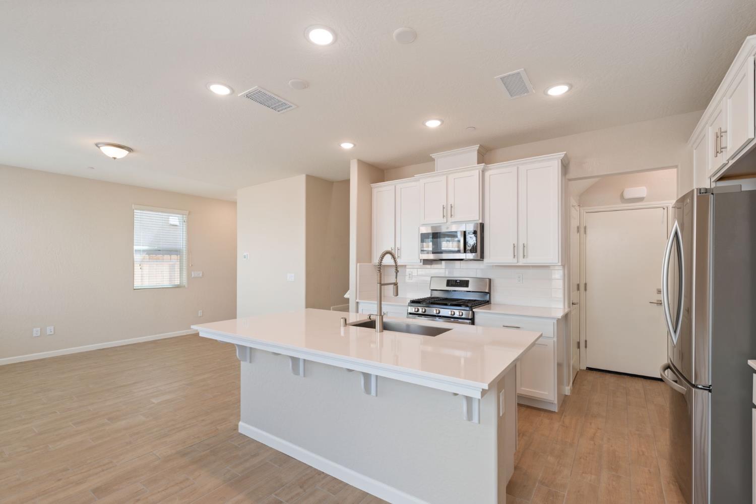 1109 Royalty Way West Madera, CA 93636 - Photo 11 of 47 a kitchen with stainless steel appliances a refrigerator sink and microwave