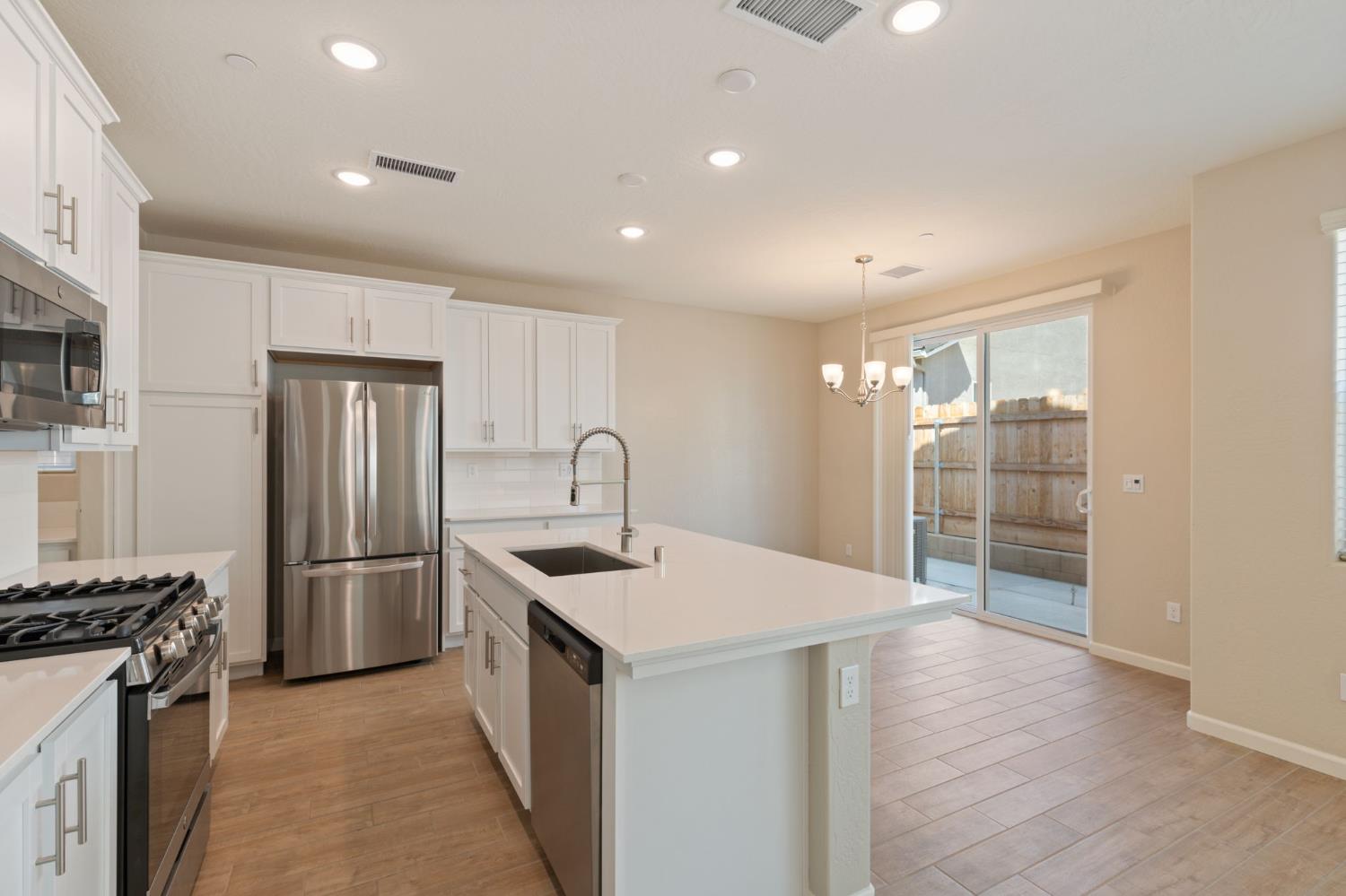 1109 Royalty Way West Madera, CA 93636 - Photo 13 of 47 a kitchen with stainless steel appliances granite countertop a refrigerator and a sink