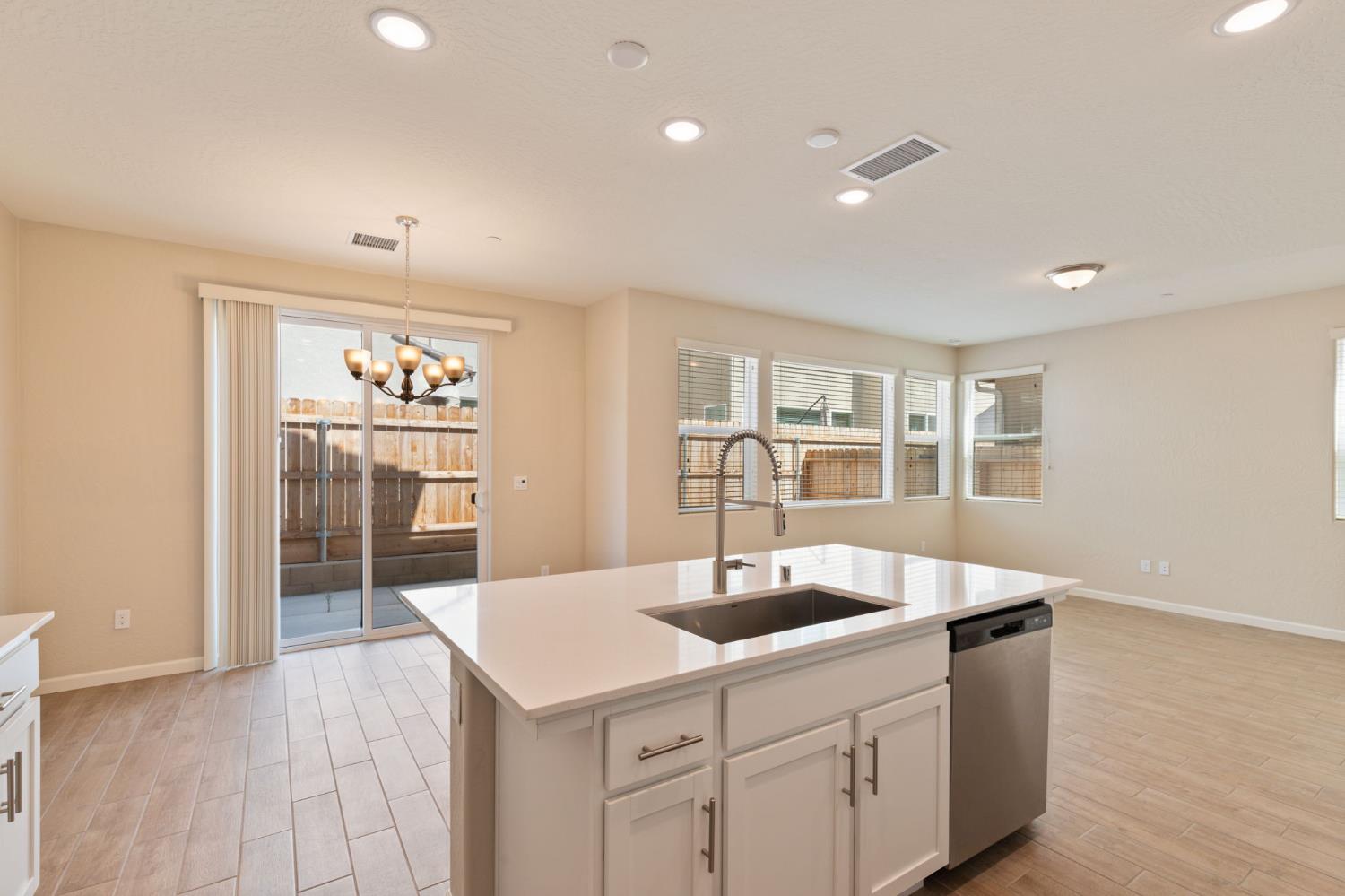 1109 Royalty Way West Madera, CA 93636 - Photo 14 of 47 a kitchen with a sink and chandelier