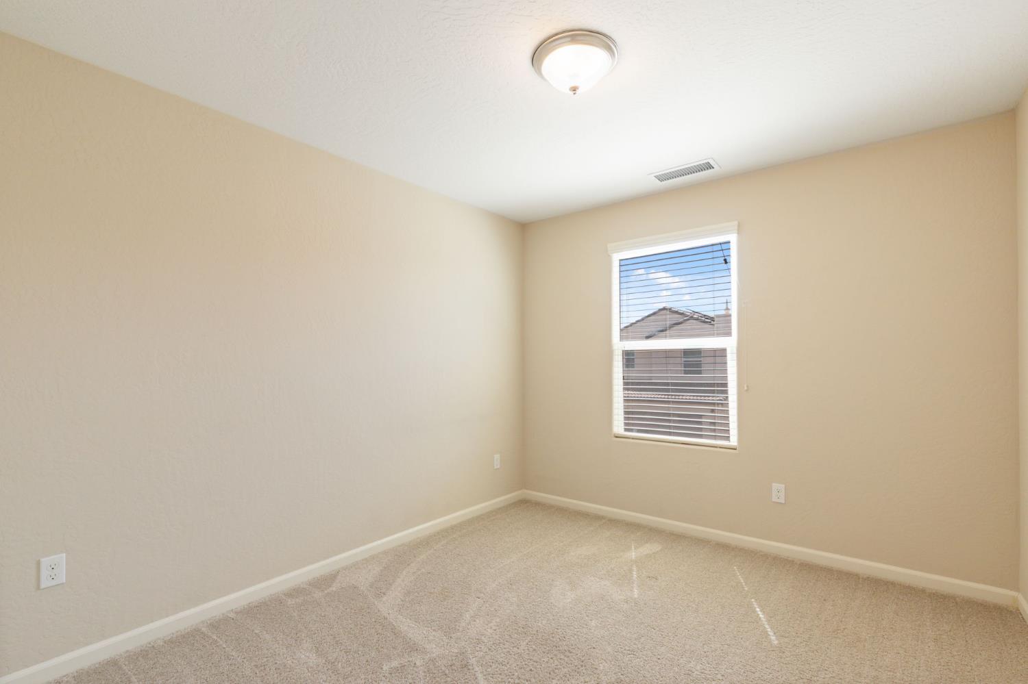 1109 Royalty Way West Madera, CA 93636 - Photo 18 of 47 an empty room with a window