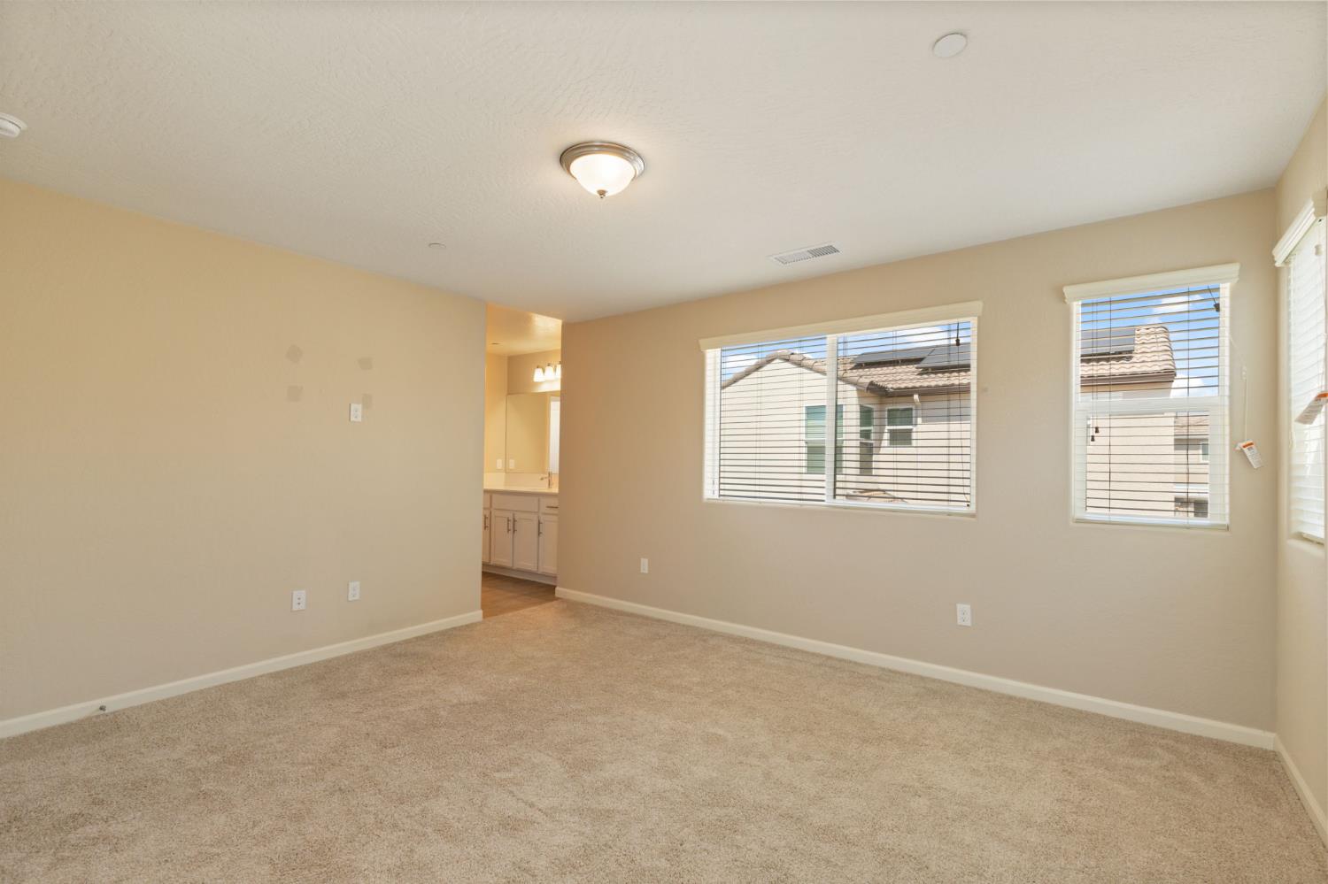 1109 Royalty Way West Madera, CA 93636 - Photo 22 of 47 an empty room with windows
