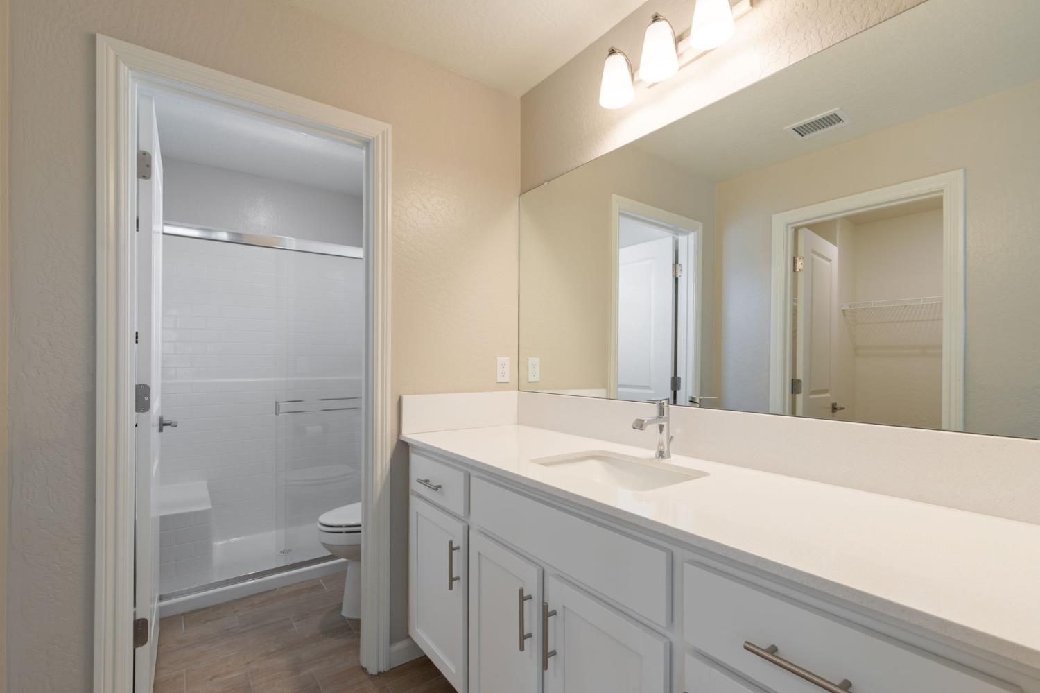 1109 Royalty Way West Madera, CA 93636 - Photo 24 of 47 a bathroom with a sink a toilet and shower