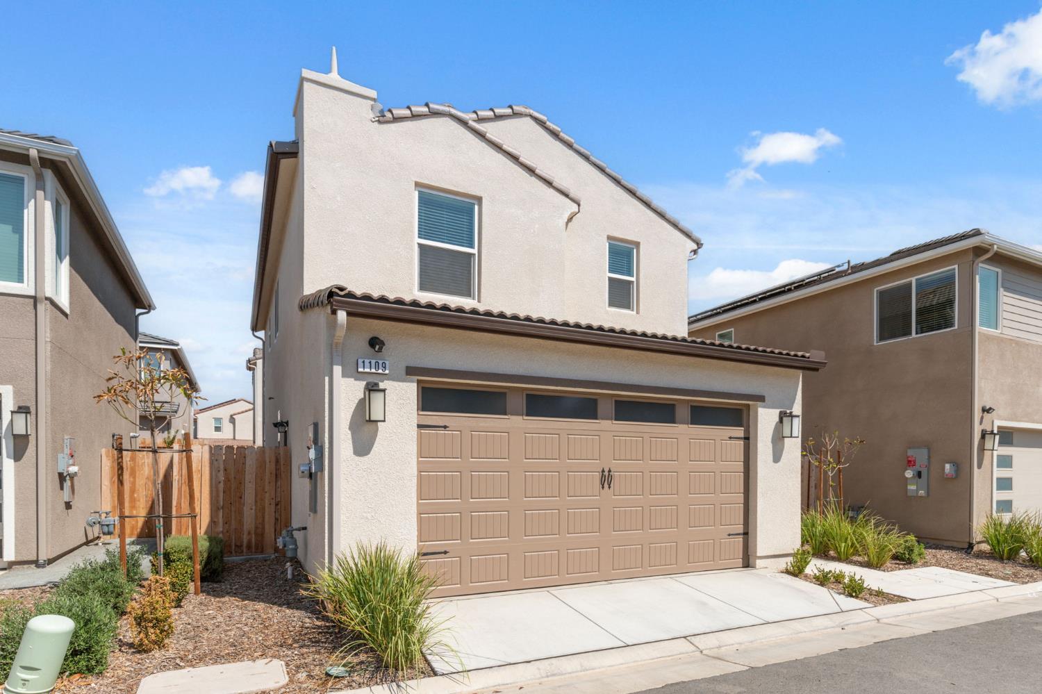 1109 Royalty Way West Madera, CA 93636 - Photo 3 of 47 a front view of a house with a garage