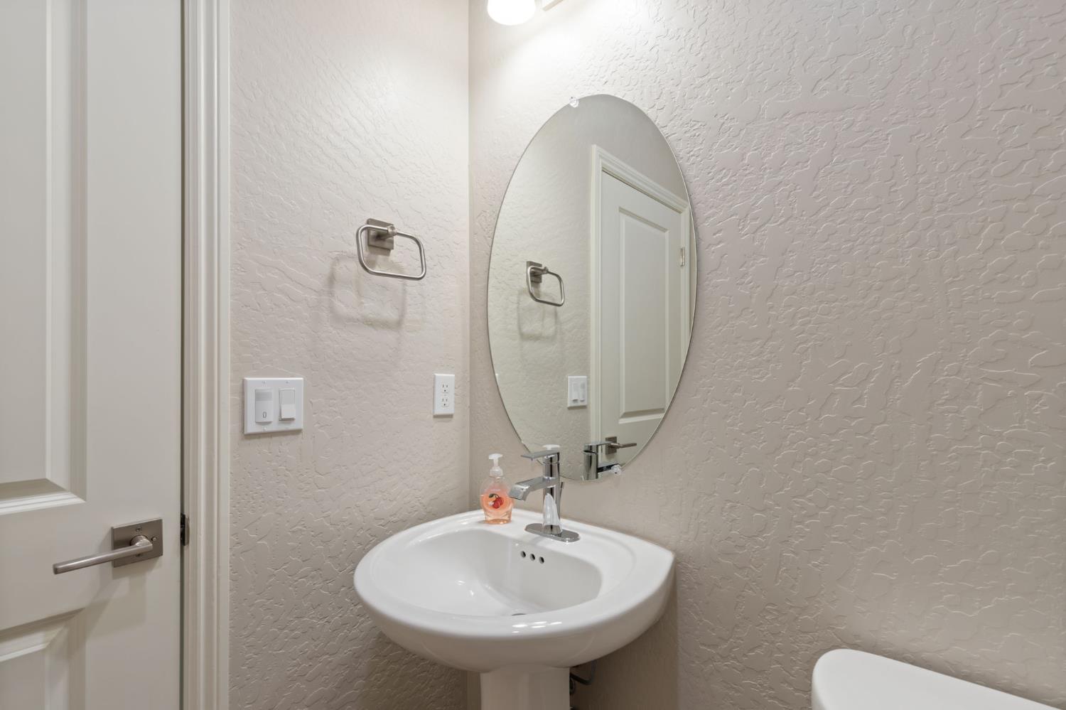 1109 Royalty Way West Madera, CA 93636 - Photo 6 of 47 a bathroom with a sink mirror and toilet