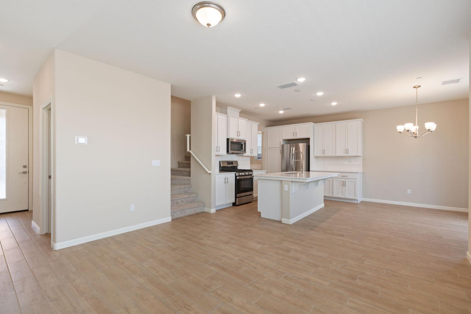 1109 Royalty Way West Madera, CA 93636 - Photo 9 of 47 a view of kitchen with kitchen island white cabinets and stainless steel appliances