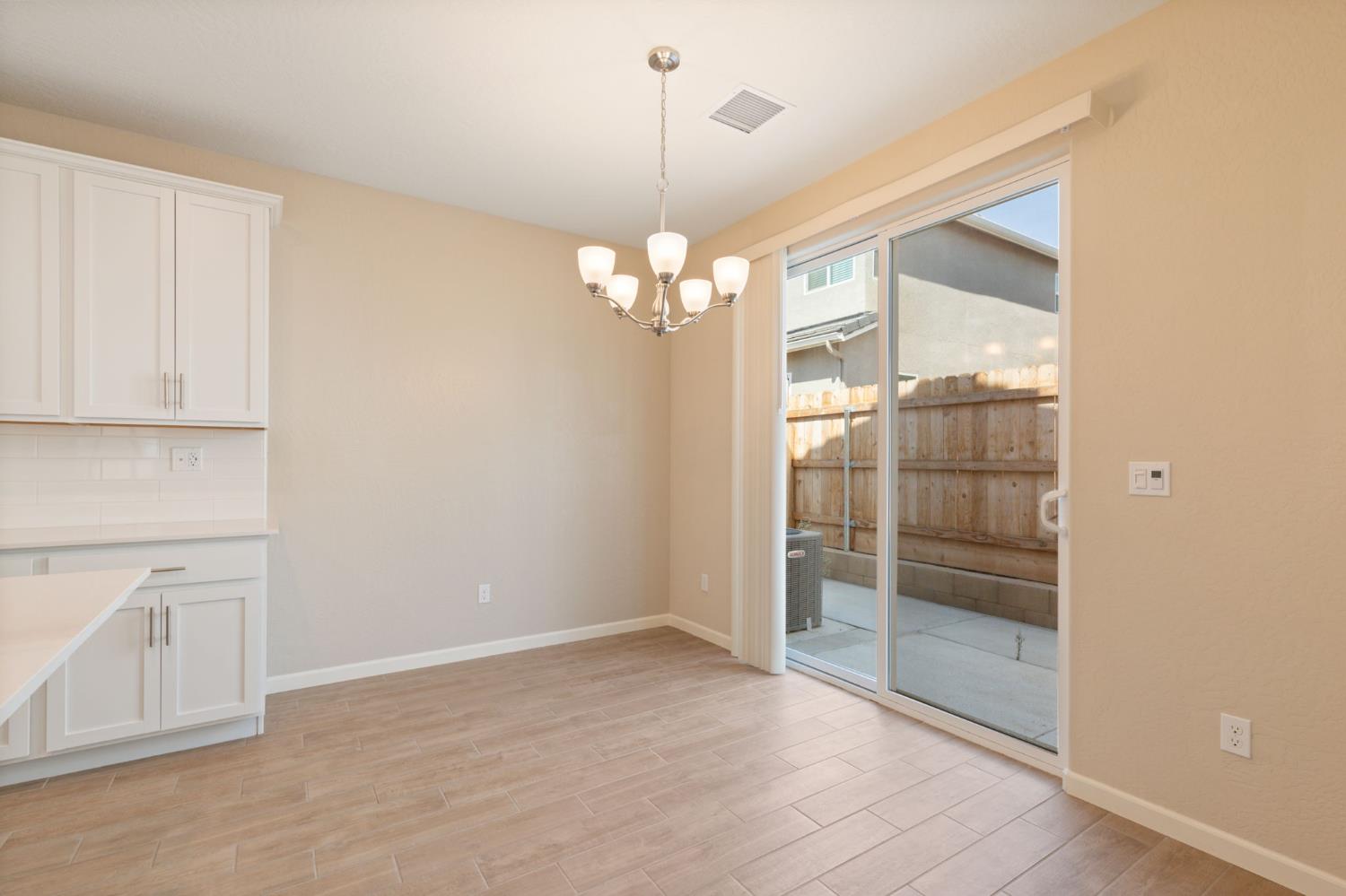 1109 Royalty Way West Madera, CA 93636 - Photo 10 of 47 a view of a room with wooden floor and windows