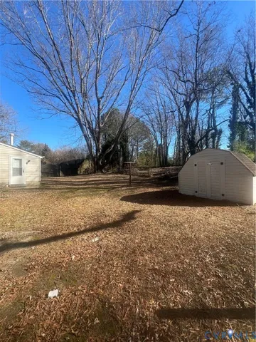 a backyard of a house with a large tree