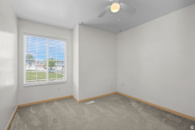 142 East 2675th Street South Clearfield, UT 84015 - Photo 25 of 49 Room featuring a large window with white blinds, neutral carpeting, and a ceiling fan with integrated lighting