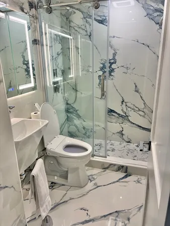 a kitchen with stainless steel appliances granite countertop a sink a stove cabinets and wooden floor