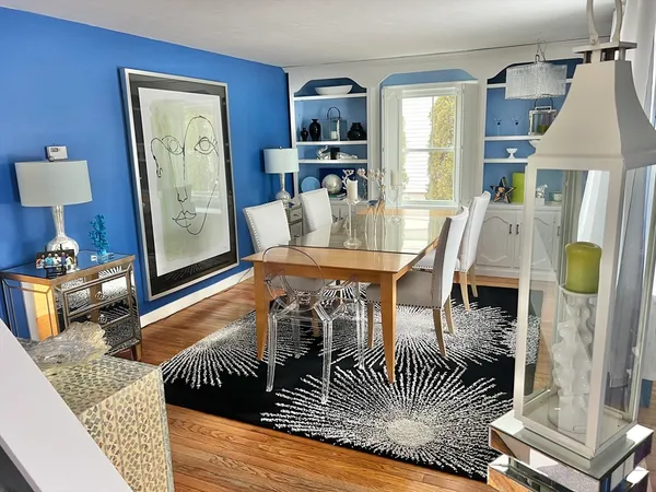 a dining room with furniture and wooden floor