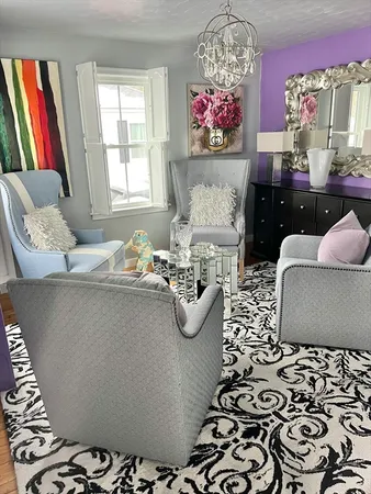 a living room with furniture and a chandelier
