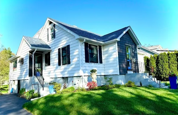 a front view of house with yard and outdoor seating