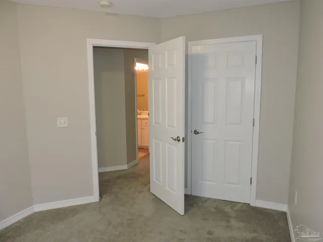 a view of an empty room with closet area