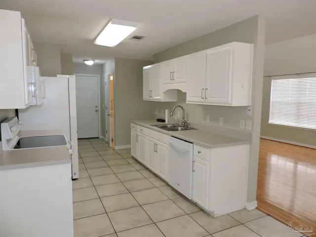 a kitchen with a sink cabinets and window