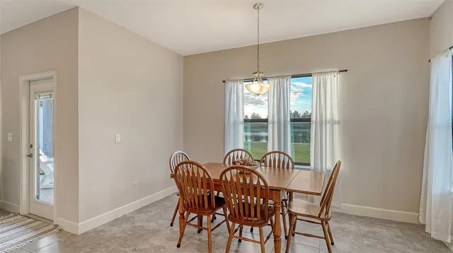 a view of a dining room with furniture window and outside view
