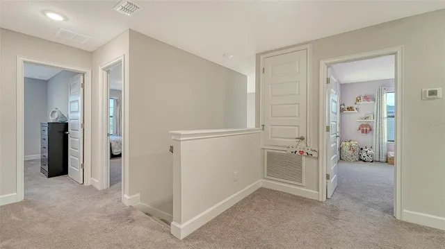 a bedroom with a bed and a flat tv screen on dresser