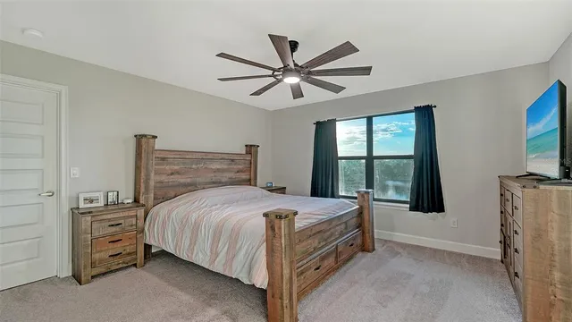 a bedroom with a large bed and a large window