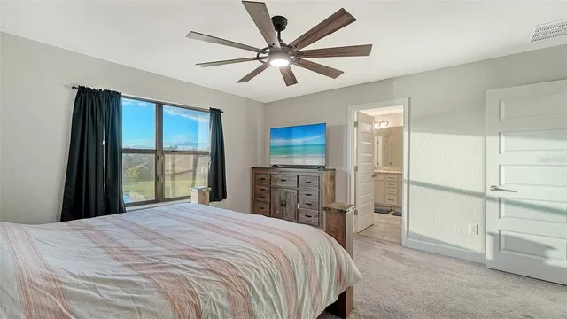 a bedroom with a bed and a chandelier