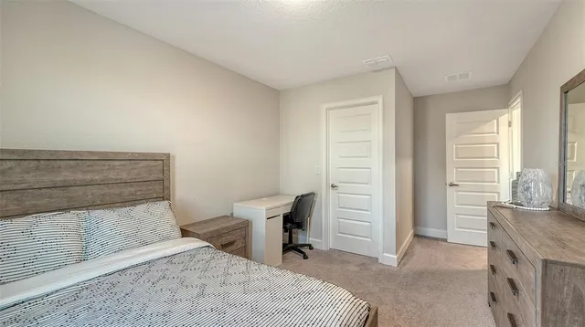 a bedroom with a bed and a dresser