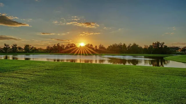 a view of a lake with houses in the back