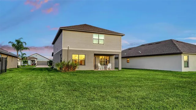 an aerial view of residential houses with outdoor space and swimming pool