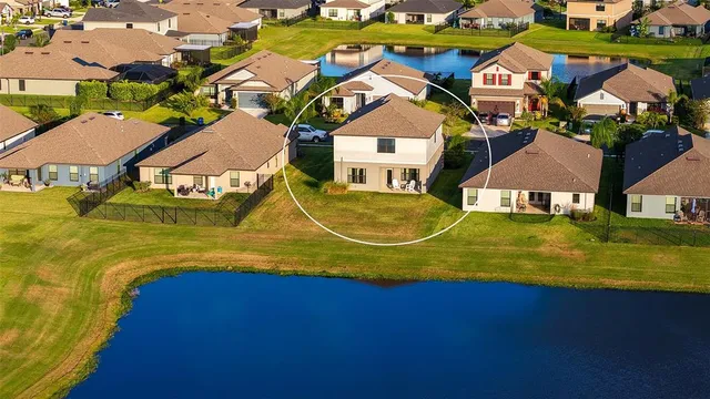 an aerial view of a house with a lake view