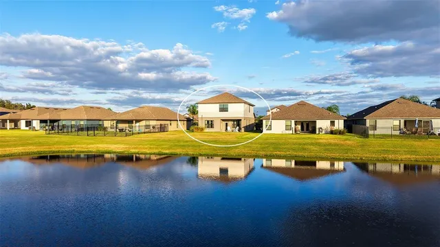 a front view of house with outdoor space and lake view