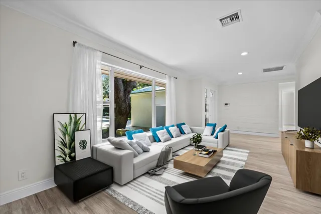 a view of a kitchen with wooden floor and electronic appliances
