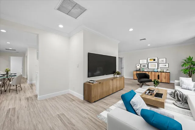 a view of a room with wooden floor and a ceiling fan