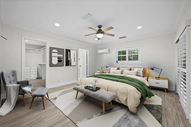 a view of empty room with wooden floor and ceiling fan