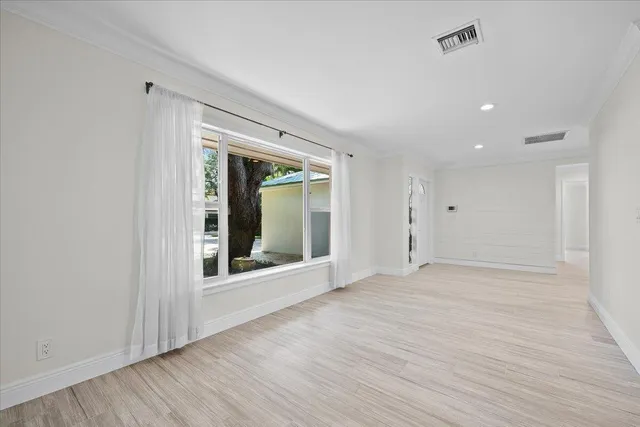 an aerial view of residential houses with outdoor space and trees