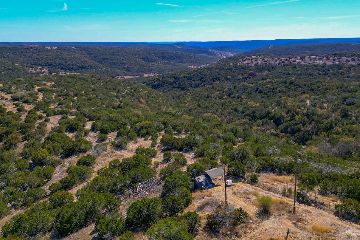 Undisclosed Address Rocksprings, TX 78880 - Photo 1 of 11 Aerial view of property's location featuring a heavily wooded area