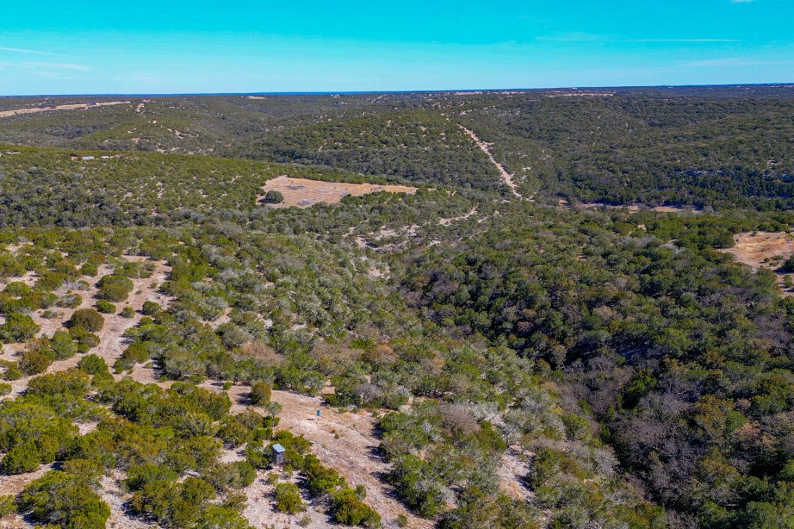 Undisclosed Address Rocksprings, TX 78880 - Photo 4 of 11 Aerial view of property and surrounding area featuring a heavily wooded area