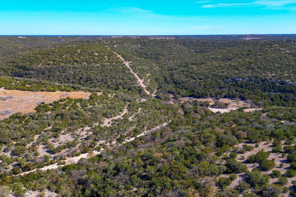 Undisclosed Address Rocksprings, TX 78880 - Photo 5 of 11 Aerial overview of property's location with a heavily wooded area