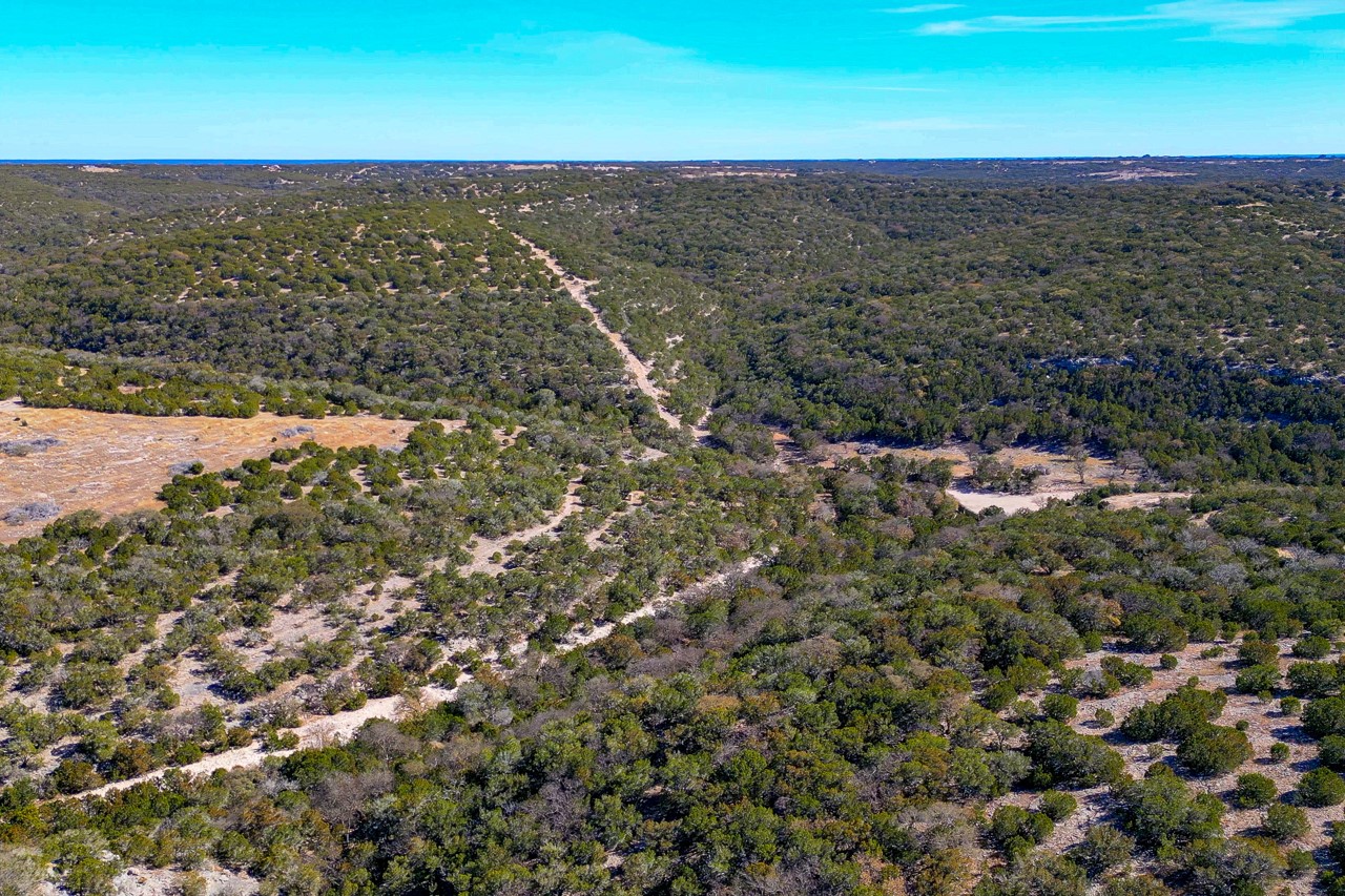 Undisclosed Address Rocksprings, TX 78880 - Photo 5 of 11 Aerial overview of property's location with a heavily wooded area